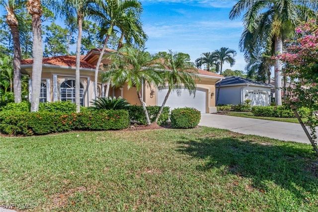 mediterranean / spanish-style house featuring a front yard and a garage