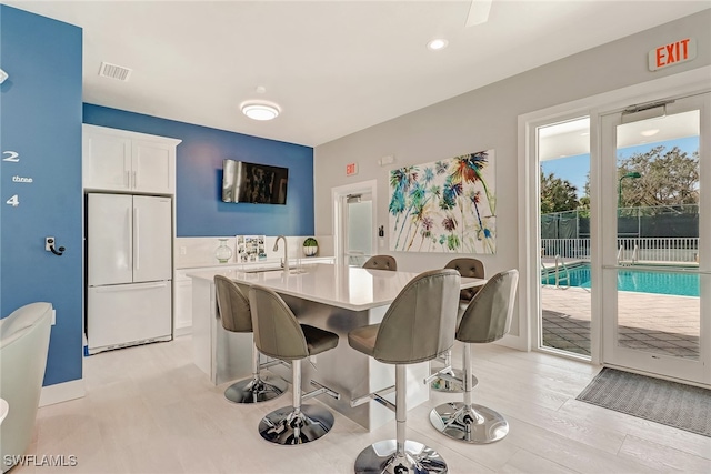 dining space featuring sink and light hardwood / wood-style flooring