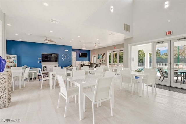 dining area with ceiling fan, french doors, and light hardwood / wood-style flooring