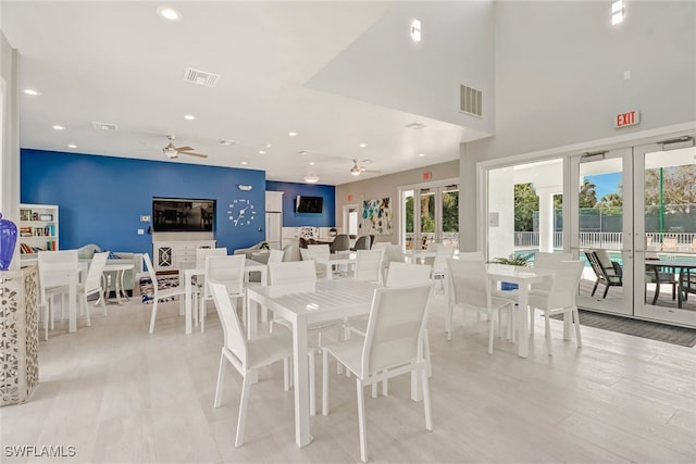 dining area featuring ceiling fan, french doors, and light wood-type flooring