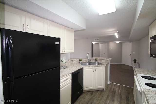 kitchen featuring white cabinets, black appliances, sink, and dark hardwood / wood-style flooring