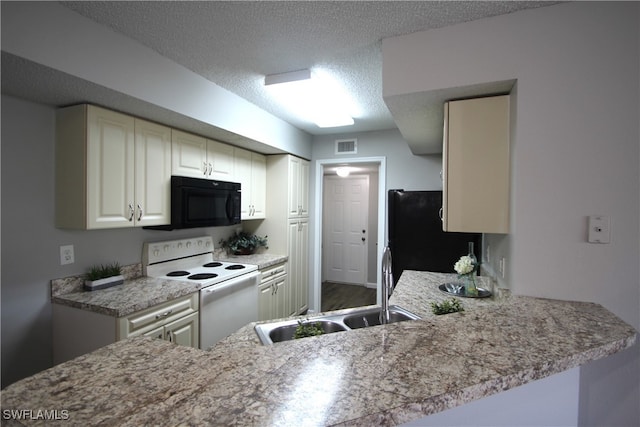 kitchen featuring sink, black appliances, kitchen peninsula, and a textured ceiling