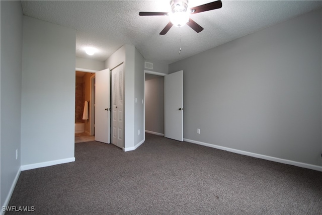 unfurnished bedroom with dark carpet, a textured ceiling, a closet, and ceiling fan