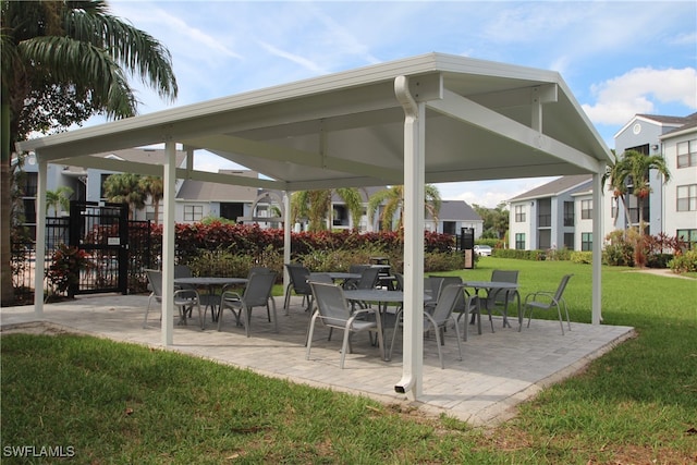 view of community with a gazebo, a patio, and a lawn