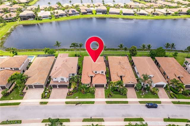 birds eye view of property with a water view