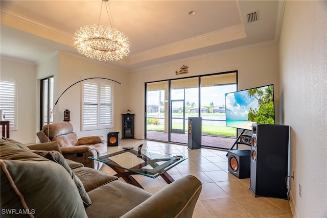 tiled living room featuring a raised ceiling, ornamental molding, and a chandelier