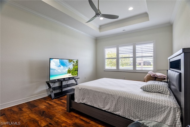 bedroom featuring ceiling fan, crown molding, dark hardwood / wood-style flooring, and a raised ceiling