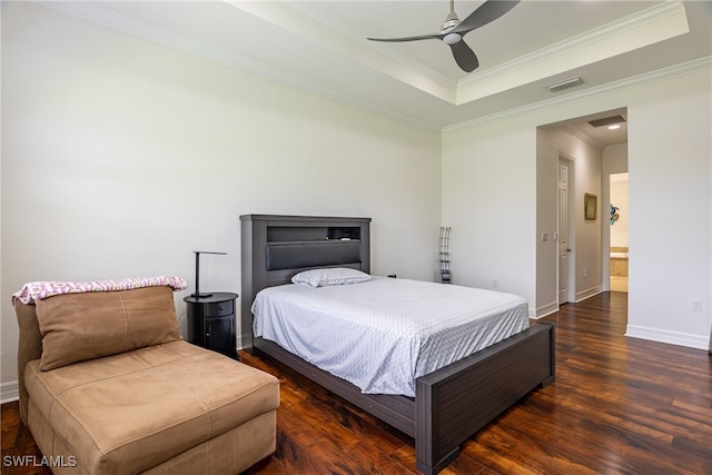 bedroom with ensuite bath, a tray ceiling, ceiling fan, crown molding, and dark hardwood / wood-style floors