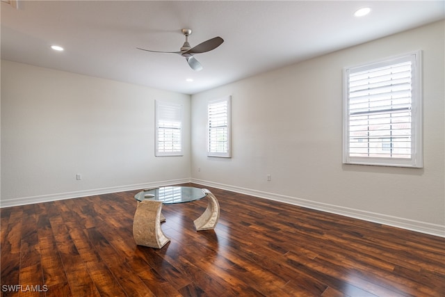 empty room with a wealth of natural light, ceiling fan, and dark hardwood / wood-style flooring