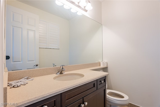 bathroom with vanity and toilet