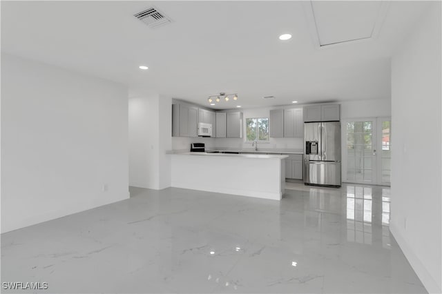 unfurnished living room featuring plenty of natural light