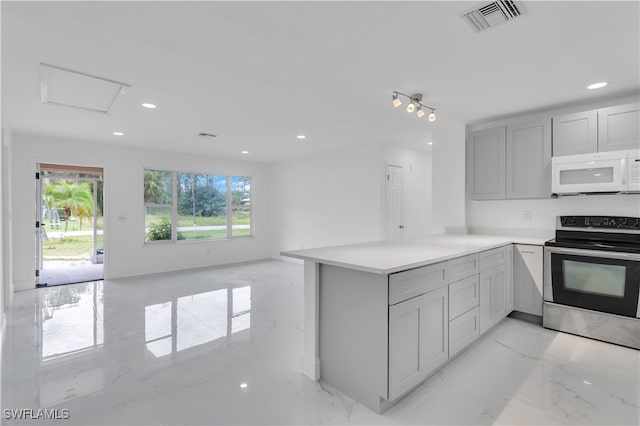 kitchen with kitchen peninsula, electric range, and gray cabinetry