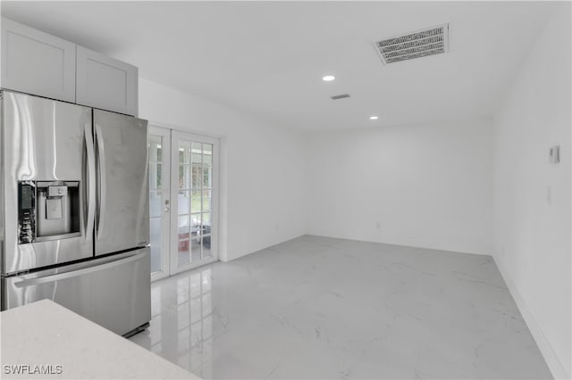 kitchen with white cabinets, stainless steel fridge with ice dispenser, and french doors