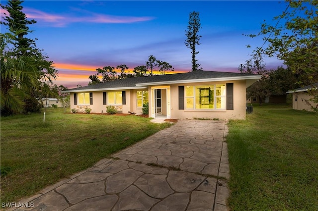 ranch-style home featuring a yard