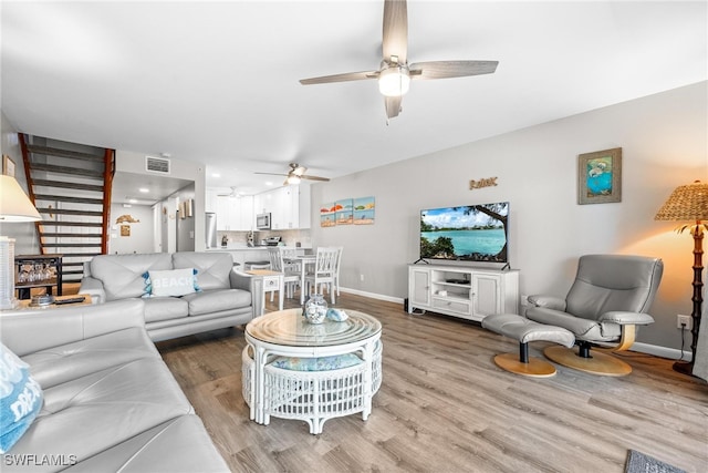 living room with ceiling fan and wood-type flooring