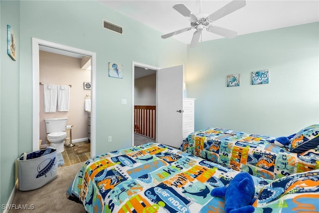 bedroom featuring hardwood / wood-style floors, ensuite bathroom, and ceiling fan