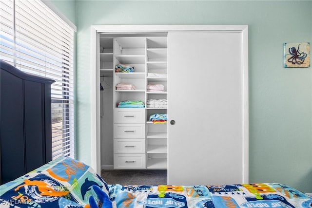 carpeted bedroom featuring a closet