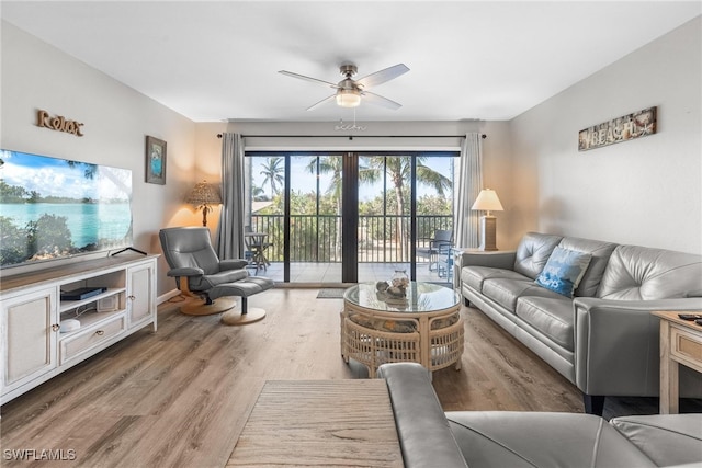 living room with hardwood / wood-style floors and ceiling fan