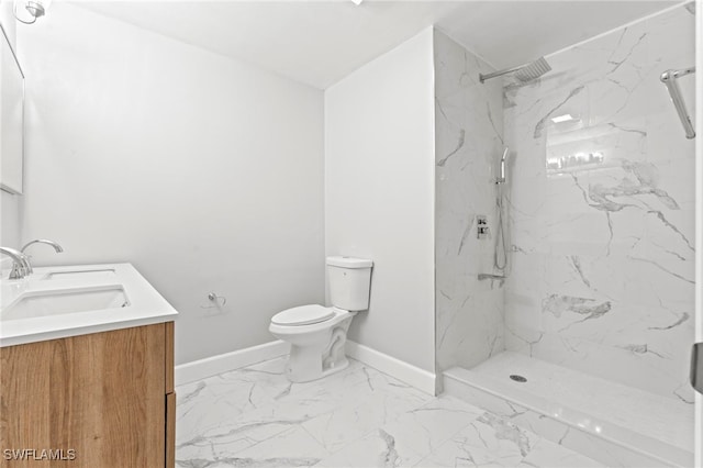 bathroom featuring a tile shower, toilet, and vanity