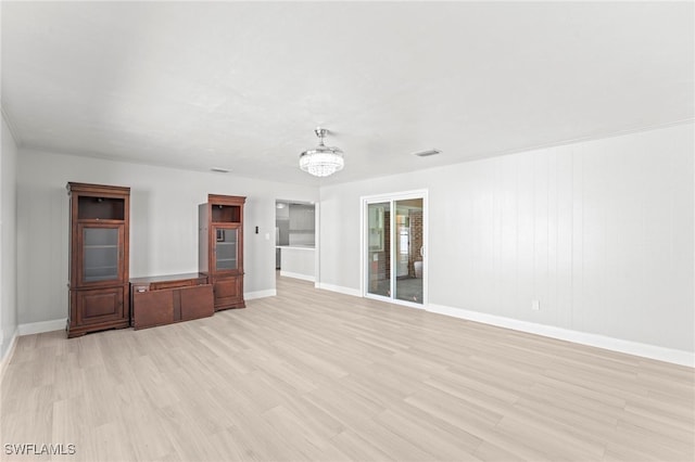 unfurnished bedroom with a chandelier and light hardwood / wood-style flooring