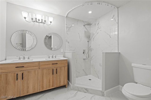 bathroom featuring vanity, toilet, and a tile shower