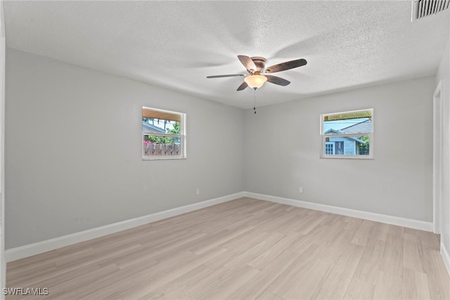 unfurnished room with light hardwood / wood-style flooring, a textured ceiling, and ceiling fan