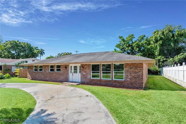 ranch-style house with a front lawn