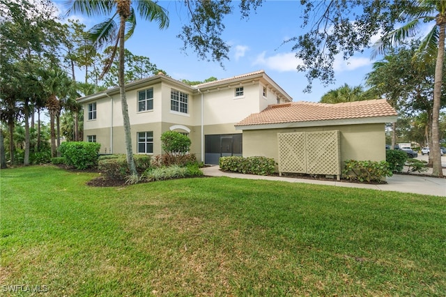 rear view of property featuring a lawn