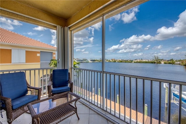 sunroom featuring a healthy amount of sunlight and a water view