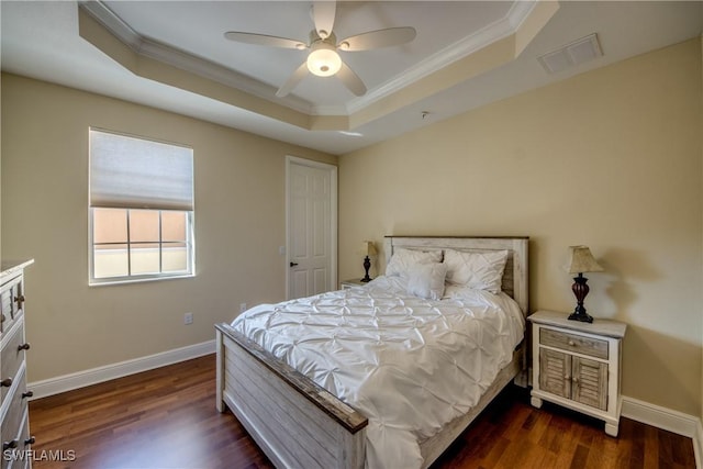 bedroom featuring a tray ceiling, baseboards, visible vents, and dark wood-style flooring