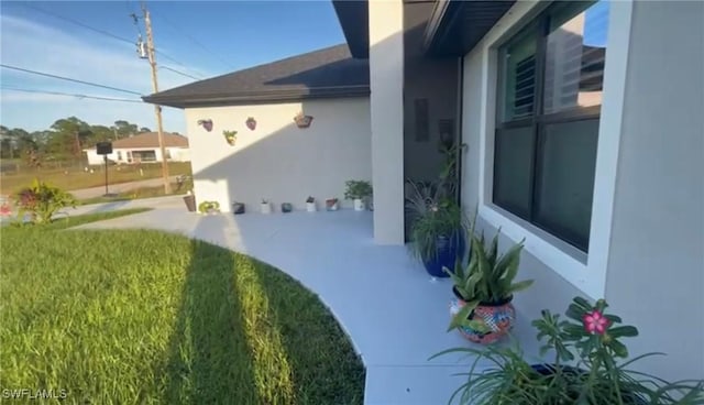 view of property exterior with a patio area and stucco siding