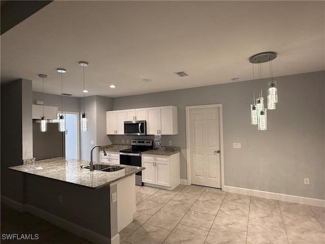 kitchen with a sink, white cabinetry, visible vents, appliances with stainless steel finishes, and light stone countertops