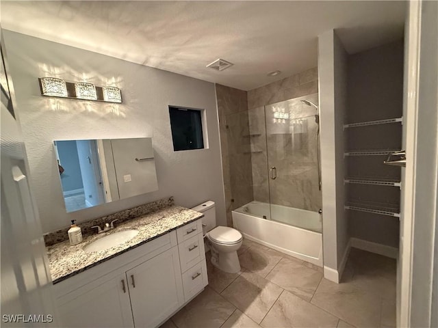 full bath with visible vents, toilet, marble finish floor, combined bath / shower with glass door, and vanity