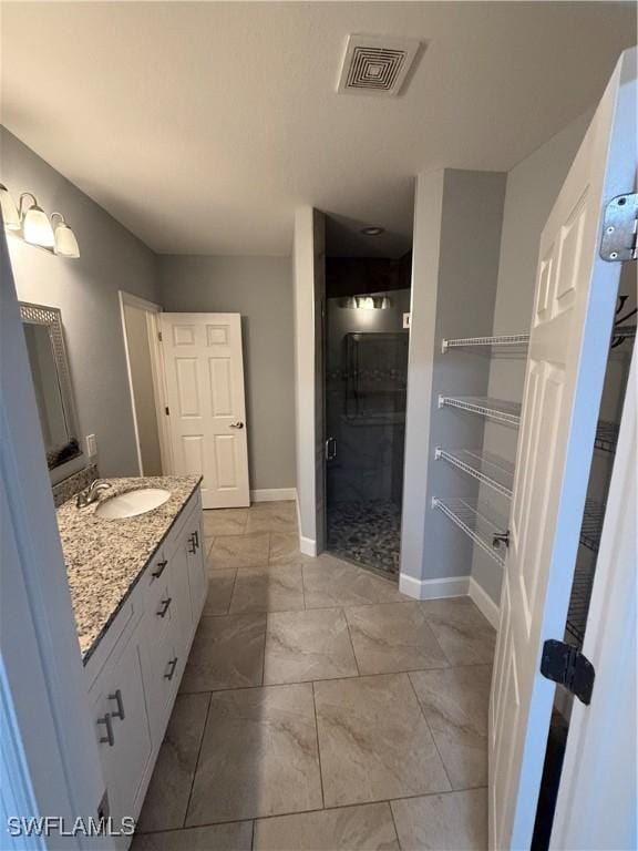 bathroom featuring marble finish floor, baseboards, visible vents, and vanity