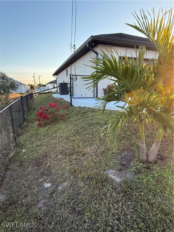 exterior space featuring cooling unit and fence