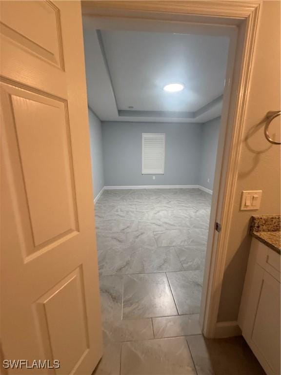 interior space featuring marble finish floor and baseboards