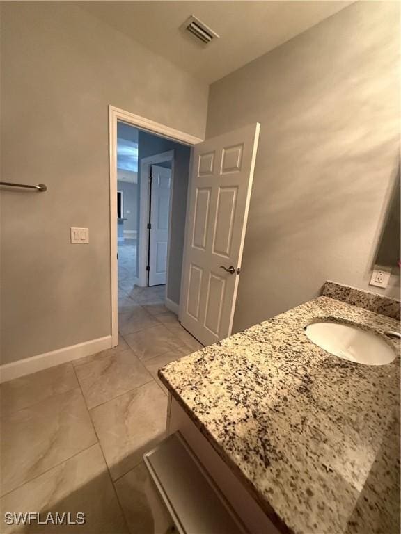 bathroom featuring vanity, visible vents, and baseboards