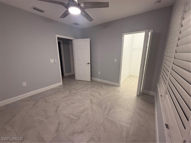 unfurnished bedroom with marble finish floor, visible vents, and baseboards