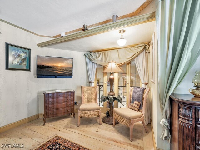 sitting room with hardwood / wood-style flooring