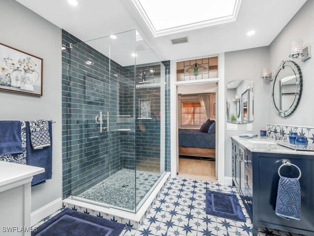 bathroom featuring vanity and a shower with door