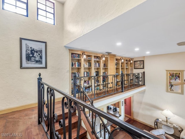 corridor with hardwood / wood-style flooring