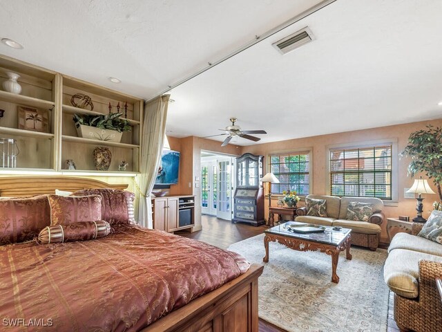 bedroom featuring dark wood-type flooring, access to outside, and ceiling fan