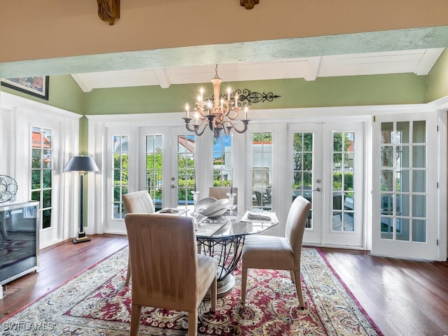 dining area featuring french doors, wood-type flooring, and a notable chandelier