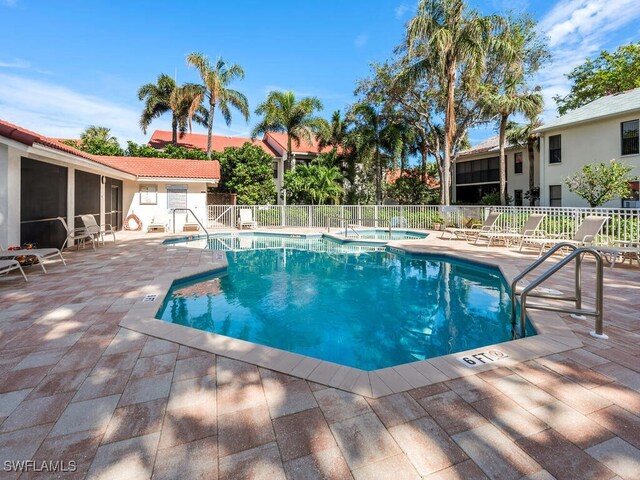 view of swimming pool with a community hot tub and a patio