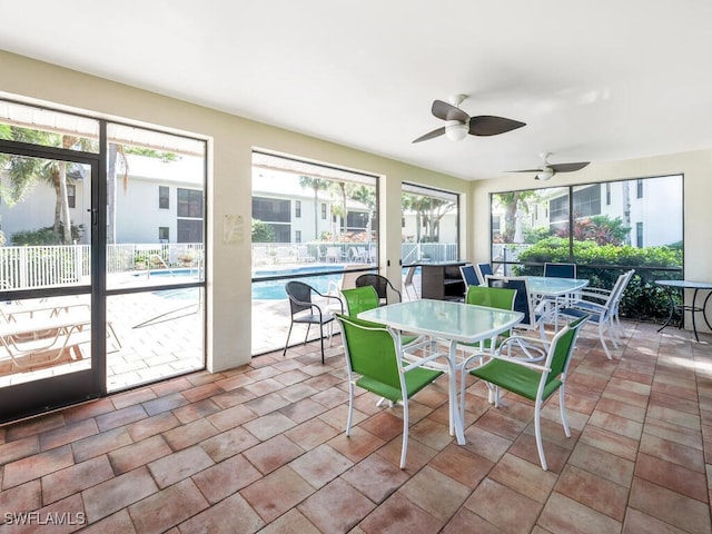 sunroom with plenty of natural light and ceiling fan