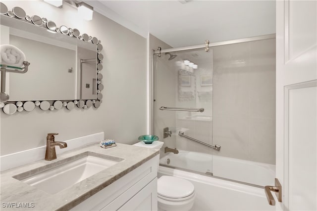 full bathroom featuring toilet, combined bath / shower with glass door, and vanity