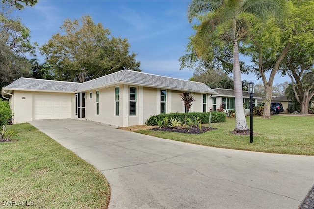 ranch-style house featuring a front lawn and a garage