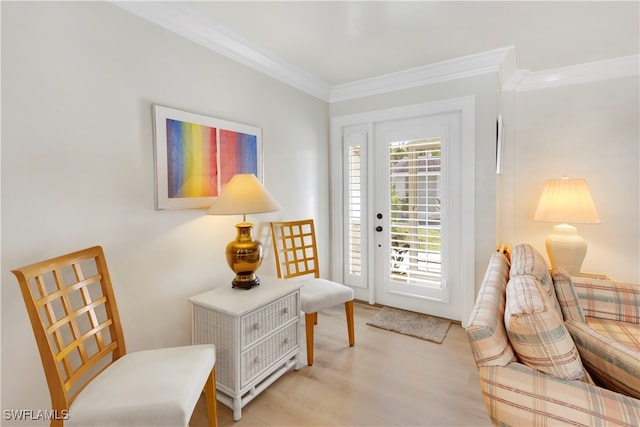 sitting room featuring ornamental molding and light hardwood / wood-style floors