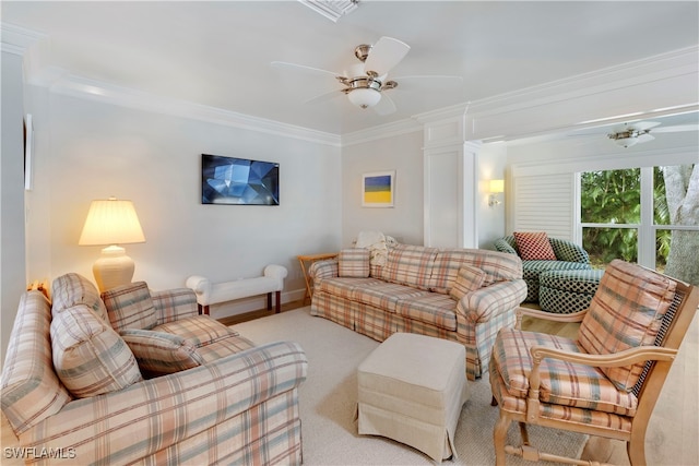 living room with decorative columns, ceiling fan, light carpet, and ornamental molding