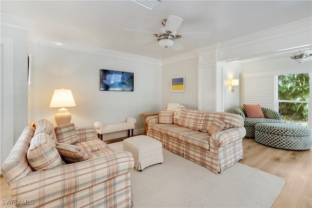 living room featuring ceiling fan, ornate columns, light hardwood / wood-style flooring, and crown molding